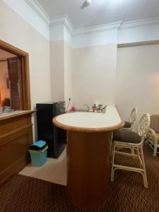 a kitchen with a round table and two chairs at Riviera Bay Resort Condominium in Kampong Lereh