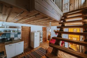 a kitchen with wooden floors and a staircase in a house at Uue-Ringi Holiday in Puise +38 photos