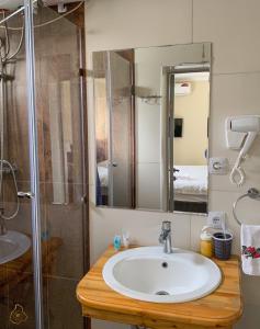 a bathroom with a sink and a shower at OSH ART Meergul in Osh +133 photos