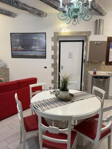 a kitchen and dining room with a white table and chairs at casa vacanza serena in Palazzago +81 photos