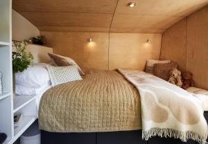 a bedroom with two beds and a teddy bear at Boutique Barges in London
