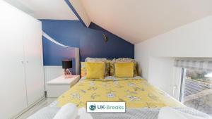 a bedroom with a yellow bed with yellow pillows at 18 Main Street in Egremont