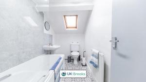 a bathroom with a tub and a toilet and a sink at 18 Main Street in Egremont