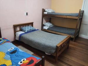 a room with two bunk beds and a table at Casa piedra cartagena in Cartagena