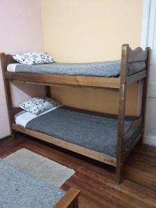 two bunk beds in a room with a rug at Casa piedra cartagena in Cartagena