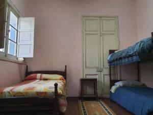 a room with two bunk beds and a window at Casa piedra cartagena in Cartagena