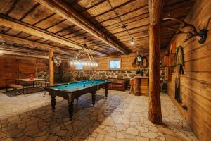 a pool table in a room with wooden walls at Uue-Ringi Holiday in Puise