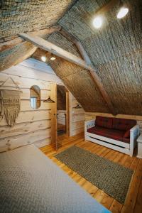 a room with a couch in the middle of a attic at Uue-Ringi Holiday in Puise