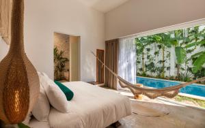 a bedroom with a hammock bed and a large window at Olbil Hotel Boutique in Valladolid