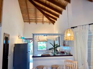 uma cozinha com um frigorífico, uma mesa e cadeiras em Playa Bonita 4 minute walk from our private Villa Anantara Bonita em Las Terrenas