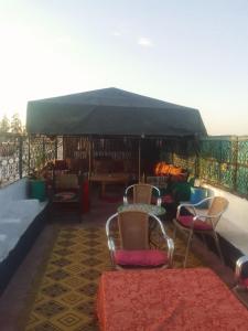 a group of chairs and tables on a balcony at Riad Dar Zaida in Marrakesh