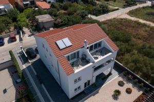 an overhead view of a white house with a roof at Apartment Fiorino in Zadar