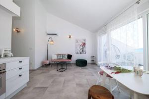 a kitchen with a table and chairs in a room at Apartment Fiorino in Zadar