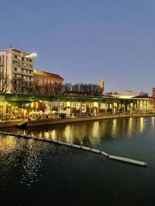 vista su un fiume con edifici sullo sfondo di Ritorno alle origini Suites a Milano