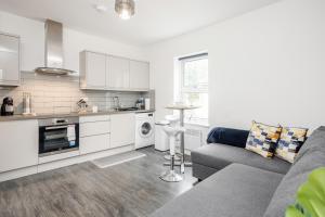 a kitchen and living room with a couch and a table at 1BR Victorian House near Bedford City Centre in Bedford