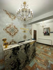 a lobby with a chandelier and a marble counter at Shirbakyan Boutique Hotel & Apartments in Yerevan