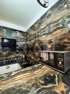 a kitchen with a marble wall with a microwave at Shirbakyan Boutique Hotel & Apartments in Yerevan