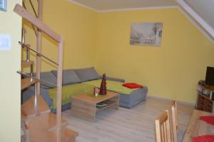 a living room with a bed and a couch at Apartamenty MoToJar in Stronie Śląskie