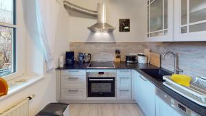 a kitchen with a sink and a stove top oven at Ferienwohnung Christine in Bischofswiesen