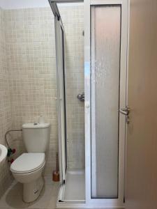 a bathroom with a toilet and a glass shower at Love House Tanger in Tangier