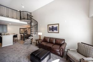 a living room with a couch and a spiral staircase at Family Getaway-Skiing, Ice Castles & Golf Course 2204 apts in Midway
