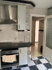 a kitchen with a sink and a stove top oven at Apartamento Al Andalus in Baena