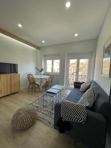 a living room with a couch and a table at The Swallows Nest in Lisbon