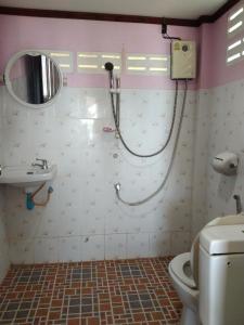 a bathroom with a shower and a toilet and a sink at Three Monkeys Bungalows Koh Yao Noi in Ko Yao Noi