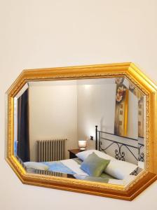 a mirror on a wall with a bed in a room at il Sole di Baggio in Milan