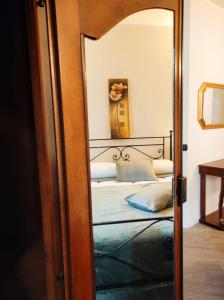 a mirror reflection of a bed in a bedroom at il Sole di Baggio in Milan