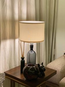 a table with a lamp and a bowl on it at Out of Mood ! luxury stay!! Abu Dhabi Yas Island in Abu Dhabi