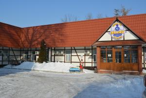 a dunkin donuts building with snow in front of it at Railway Hotel in Almaty