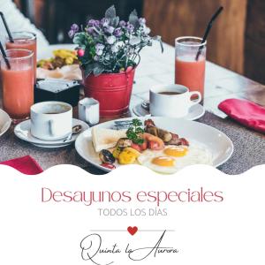 a table with a plate of breakfast food and drinks at Rústic Quinta La Aurora in Baños