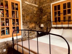 a bedroom with a bed in a stone wall at Galaria House in Moutoullas