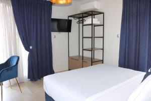 A bed or beds in a room at OLYMPUS Paradise 6