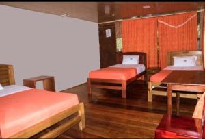 A bed or beds in a room at Caiman Lodge