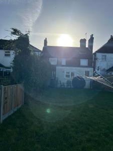 a house with the sun setting in the yard at 295 Sturry Rd in Kent