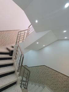 a set of stairs in a building with white ceilings at Al Hoceima Ajdir Maroc - Maison 5 chambres 10 personnes in Al Hoceïma