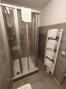 e bagno con doccia, servizi igienici e asciugamani. di Spreepolis Boardinghaus a Berlino