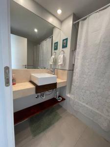 y baño con lavabo y ducha. en Moderno departamento de 52 mts en el centro en Comodoro Rivadavia