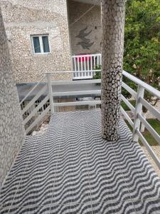 a porch with a bench and a pillar and a building at Village Galés Maragogi in Maragogi