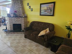 a living room with a couch and a fireplace at Casa Mirante Bixo Do Mato II in Muçum
