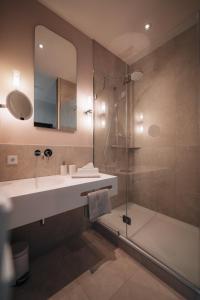 a bathroom with a sink and a shower at Hotel Amalia - Boutique Hotel in Landshut