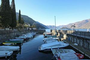 a bunch of boats are docked in the water at Bellagio Apartment San Giovanni in Bellagio