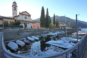 a bunch of boats are docked in a harbor at Bellagio Apartment San Giovanni in Bellagio