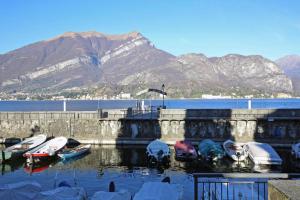 a group of boats docked in a harbor with mountains at Bellagio Apartment San Giovanni in Bellagio +8 photos