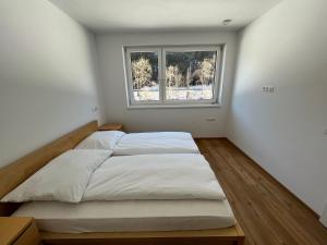 a bedroom with a bed and a window at Apartment 183 Stubaital in Fulpmes