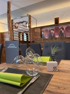 a wooden table with a glass item on top of it at Hotel Rio Bianco in Panchia