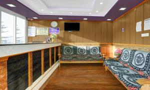 a waiting room with benches and a bar at Itsy By Treebo - Rain Forest in Ooty