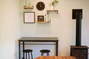 een tafel met twee krukken en een klok aan een muur bij The Cambridge House in Milwaukee +34 foto's